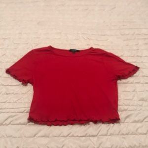 A red crop top shirt from ambiance. Only worn 1s